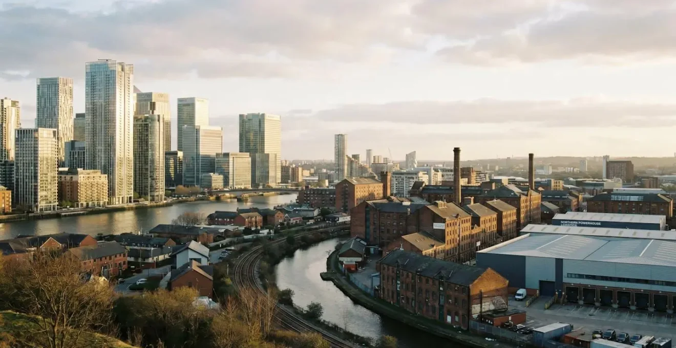 A wide urban landscape photograph comparing contrasting commercial real estate skylines with dramatic natural lighting and architectural detail